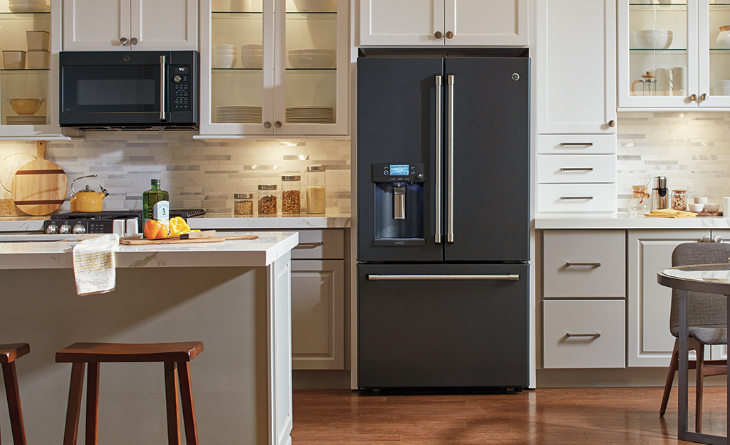 Open refrigerator in the middle of a modern kitchen setup